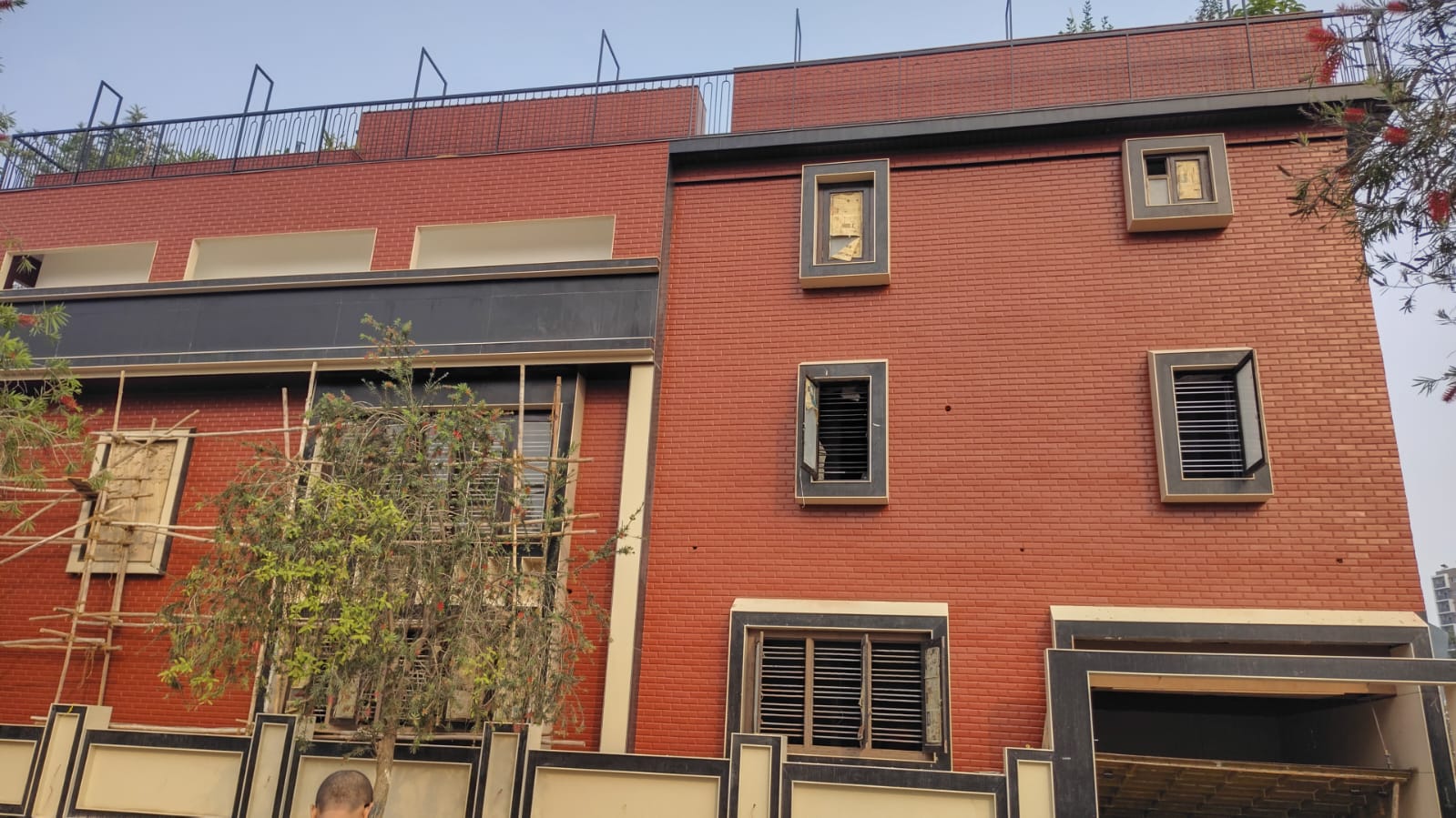 Completed red-brick residential elevation with stone cladding details
